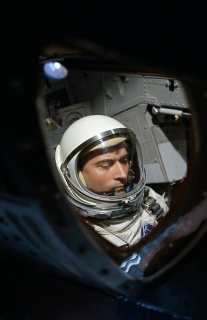 View of Astronaut John Young through spacecraft window prior to launch