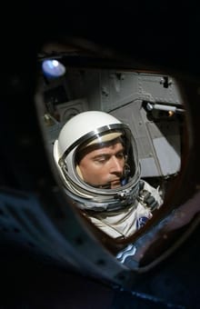 View of Astronaut John Young through spacecraft window prior to launch