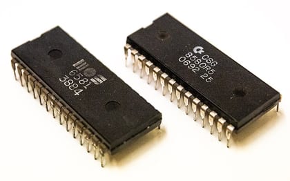 Two variants of 'SID' sound chips pulled from Commodore 64 microcomputers - a MOS 6581 an…